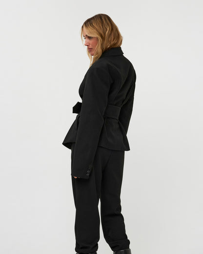 Model wearing the 264-15-1-3-19 black belted blazer and matching trousers against a white background.
